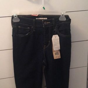 This is high rise skinny dark blue jeans.